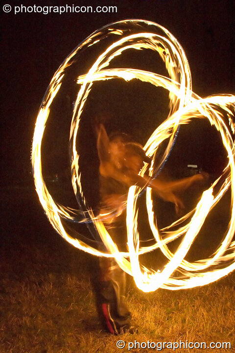 Fire sticks photographed at slow shutter speed to produce motion trails at the Turaya Gathering 2004. Wimborne, United Kingdom. © 2004 Photographicon