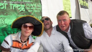 Three guys enjoy the sunshine at Waveform Project 2007. Kenton, Exeter, United Kingdom. © 2007 Photographicon