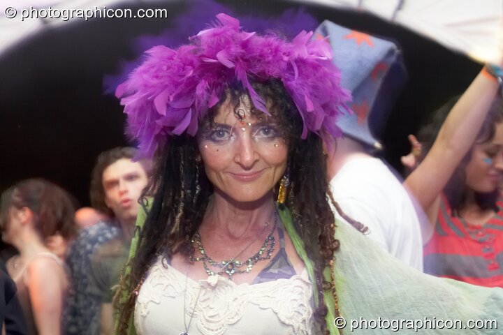 A woman with purple feather hat dances in the Gaia Chill dome at Waveform Project 2007. Kenton, Exeter, United Kingdom. © 2007 Photographicon