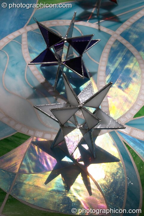 Glass objects in sunlight on an iridescent table top at Kingston Green Fair 2004. Kingston Upon Thames, United Kingdom. © 2004 Photographicon