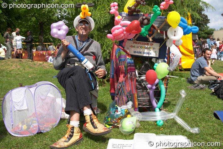 Mark Derek surrounded by his handy work with ballons at Kingston Green Fair 2004. Kingston Upon Thames, United Kingdom. © 2004 Photographicon