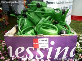 A pile of watering cans on Chessington Garden Centre's stall at Kingston Green Fair 2006. Kingston upon Thames, United Kingdom. © 2006 Photographicon