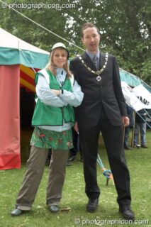A green police woman stands shoulder to shoulder with Deputy Mayor of the Royal Borough of Kingston upon Thames, Councillor Bart Ricketts, at Kingston Green Fair 2007. Kingston upon Thames, United Kingdom. © 2007 Photographicon
