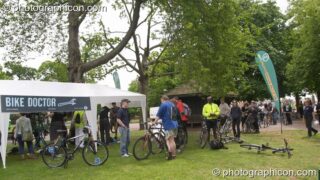 People queuing for the popular Bike Doctor free bicycle inspection service at the London Green Lifestyle Show 2005. London, United Kingdom. © 2005 Photographicon