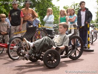 Children ride unusual pedal powered racing carts at the London Green Lifestyle Show 2005. London, United Kingdom. © 2005 Photographicon