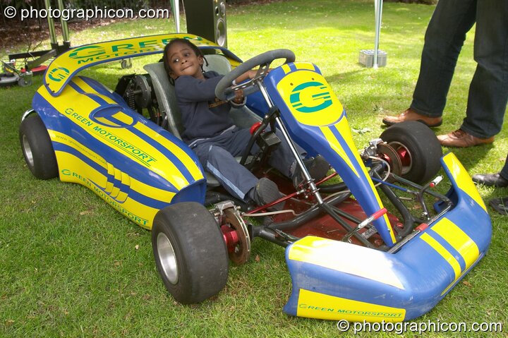 Small girl drives a Green Motorsport electric vehicle at the London Green Lifestyle Show 2005. London, United Kingdom. © 2005 Photographicon