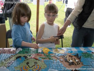 Save The World Club mosaic workshop at the London Green Lifestyle Show 2005. London, United Kingdom. © 2005 Photographicon