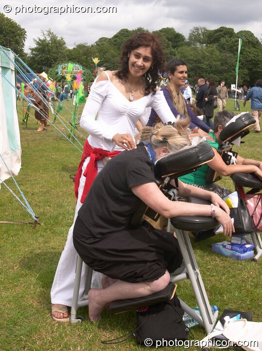 A woman gives a back massage at the London Green Lifestyle Show 2005. London, United Kingdom. © 2005 Photographicon