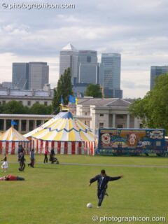 A man plays football in front of the Green Roadshow at the London Green Lifestyle Show 2005. London, United Kingdom. © 2005 Photographicon