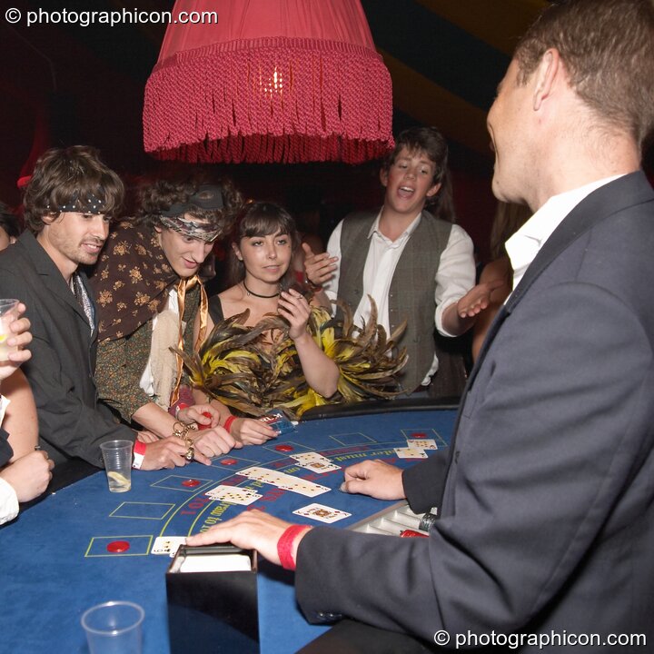 Man wins his hand on the casino card table at the Lost Vagueness Summer Party 2004. Lewes, United Kingdom. © 2004 Photographicon