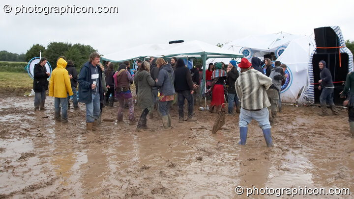 Dancers in the mud outside the Little Green Planet Stage  at the Echo Festival. Overton, United Kingdom. © 2007 Photographicon