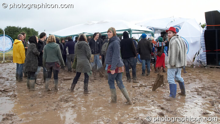 Dancers in the mud outside the Little Green Planet Stage  at the Echo Festival. Overton, United Kingdom. © 2007 Photographicon