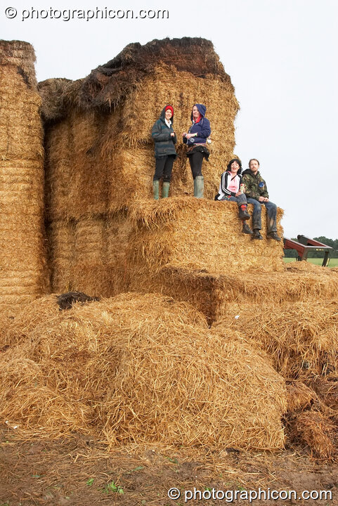 People enjoying the view from the side of a giant hay stack at the Echo Festival. Overton, United Kingdom. © 2007 Photographicon
