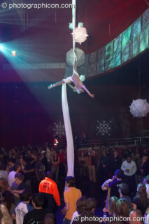 A woman from Fluorotrash performs acrobatics while hanging from silk above the main room at the Pukka / Interpole / Mindscapes Halloween party. London, United Kingdom. © 2007 Photographicon