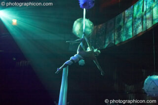 A woman from Fluorotrash performs acrobatics while hanging from silk above the main room at the Pukka / Interpole / Mindscapes Halloween party. London, United Kingdom. © 2007 Photographicon