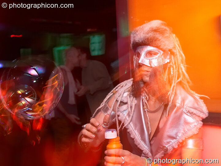 A woman playfully spins the bubbles she blows at the Pukka / Interpole / Mindscapes Halloween party. London, United Kingdom. © 2007 Photographicon