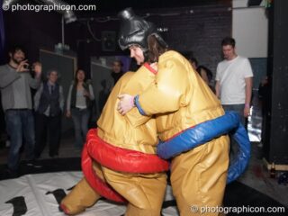 Dave and Charlie play fight in padded pseudo sumo costumes at Dave Green's birthday party. London, United Kingdom. © 2007 Photographicon