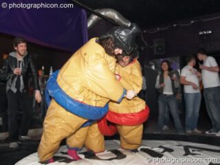 Dave and Charlie play fight in padded pseudo sumo costumes at Dave Green's birthday party. London, United Kingdom. © 2007 Photographicon