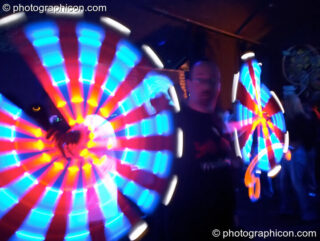 Devkev's spins his illuminated double dtaffs in the Liquid Connective space at the Synergy Project. London, United Kingdom. © 2005 Photographicon