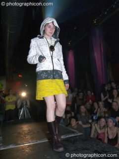 Woman stands on the catwalk modelling for an ethical fashion show at The Synergy Project. London, United Kingdom. © 2005 Photographicon