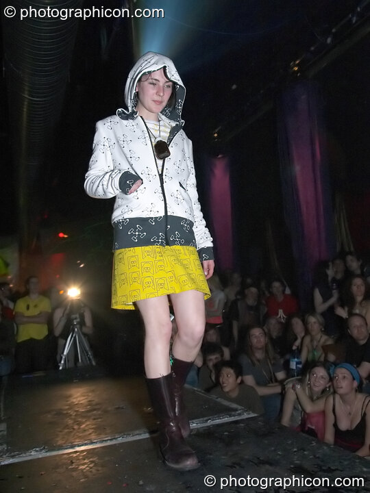 Woman stands on the catwalk modelling for an ethical fashion show at The Synergy Project. London, United Kingdom. © 2005 Photographicon