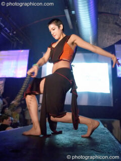 Woman stands on the catwalk modelling for an ethical fashion show at The Synergy Project. London, United Kingdom. © 2005 Photographicon