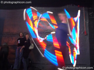 Jedi Juggler with illuminated flashing Glow Staffs, trail-blurred by slow shutter speed, at The Synergy Project. London, United Kingdom. © 2006 Photographicon