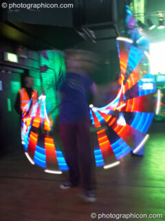 Jedi Juggler with illuminated flashing Glow Staffs, trail-blurred by slow shutter speed, at The Synergy Project. London, United Kingdom. © 2006 Photographicon