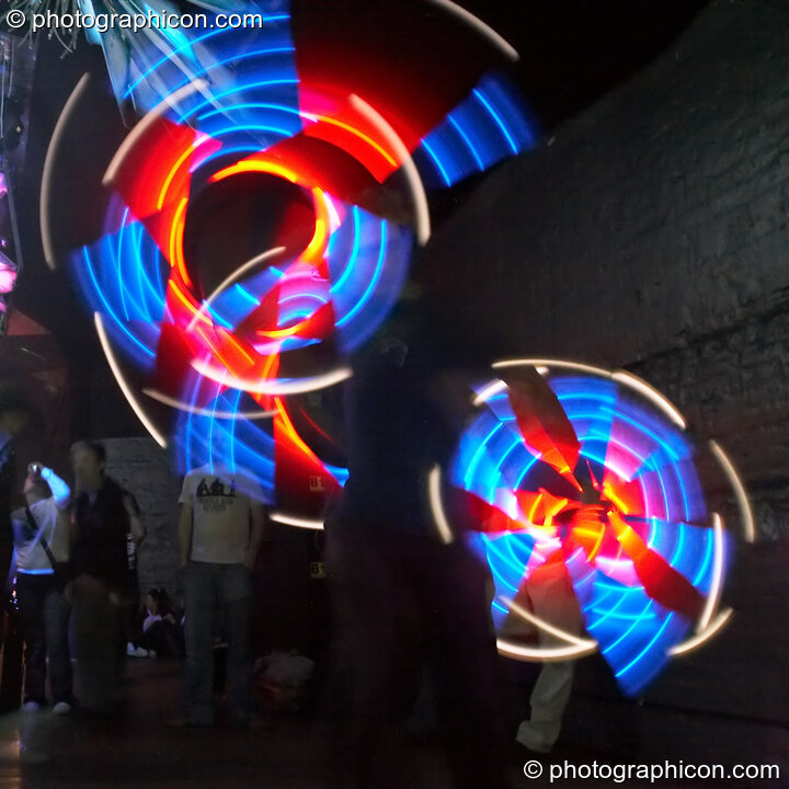 Jedi Juggler with illuminated flashing Glow Staffs, trail-blurred by slow shutter speed, at The Synergy Project. London, United Kingdom. © 2006 Photographicon