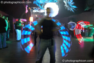 Jedi Juggler with illuminated flashing Glow Staffs, trail-blurred by slow shutter speed, at The Synergy Project. London, United Kingdom. © 2006 Photographicon