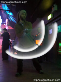 Alex the Jedi Juggler with illuminated poi, trail-blurred by slow shutter speed, at The Synergy Project. London, United Kingdom. © 2006 Photographicon