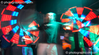 Jedi Juggler with illuminated flashing Glow Staffs, trail-blurred by slow shutter speed, at The Synergy Project. London, United Kingdom. © 2006 Photographicon