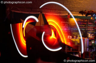 Jedi Juggler with illuminated flashing Glow Staffs, trail-blurred by slow shutter speed, at The Synergy Project. London, United Kingdom. © 2006 Photographicon