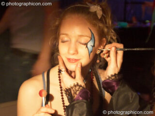 Face painting in progress at The Synergy Project. London, United Kingdom. © 2006 Photographicon