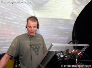 Agent Smith DJing on the Liquid Records stage with a projected backdrop by Inside-Us-All at The Synergy Project. London, United Kingdom. © 2006 Photographicon