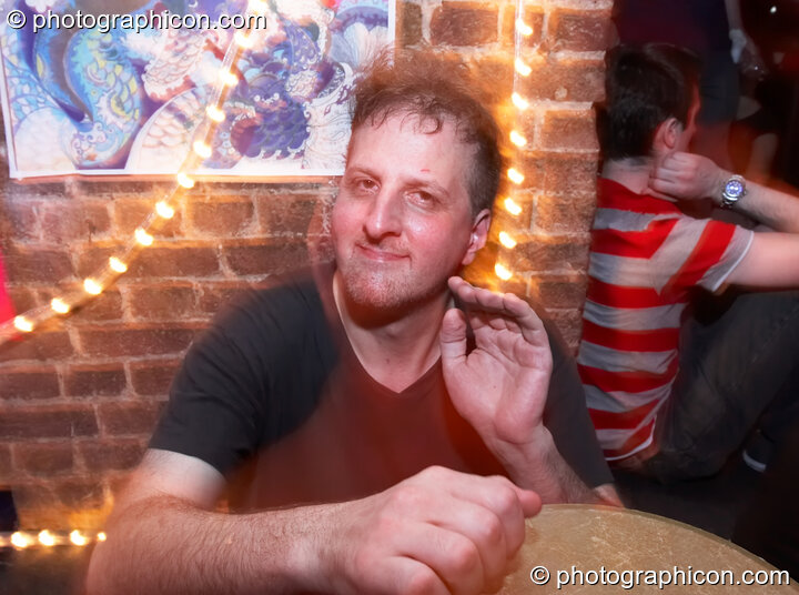 Ron is in tranced with his drum at The Synergy Project. London, United Kingdom. © 2006 Photographicon