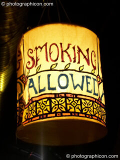 A lantern illuminated sign indicates we are in a designated smoking area at The Synergy Project. London, United Kingdom. © 2006 Photographicon