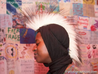 Cherylin wears a spiky hair piece stands in front of the world's largest dress in the Speak space at The Synergy Project. London, United Kingdom. © 2006 Photographicon