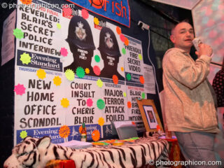 Agitprop wall posters on a stall encouraging people to send a fish-shaped post-card to Tony Blair at The Synergy Project. London, United Kingdom. © 2007 Photographicon