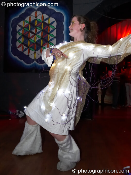 Women wearing a costume covered in light bulbs dances at The Synergy Project. London, United Kingdom. © 2007 Photographicon