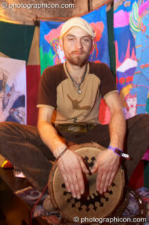 A man plays a drum in the Small World Stage at The Synergy Project. London, United Kingdom. © 2007 Photographicon