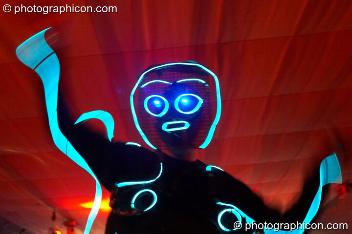 Man on stilts wearing an outfit made of Cool Neon fashioned into a stick man at The Synergy Project. London, United Kingdom. © 2007 Photographicon