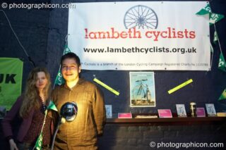 A man and woman stand by the Lambeth Cyclists stall in the Folktronica room at The Synergy Project. London, United Kingdom. © 2008 Photographicon