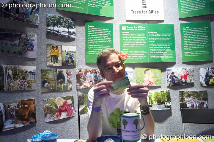 A man stils behind the Trees for Cities stall in the Folktronica room at The Synergy Project. London, United Kingdom. © 2008 Photographicon