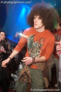 A man with large Afro hair style dances in the Galactic Fantastic room at The Synergy Project. London, United Kingdom. © 2008 Photographicon