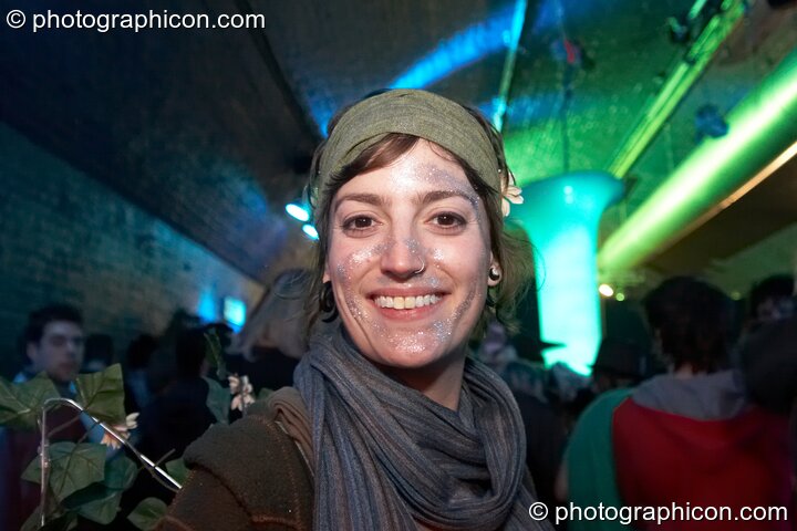 A woman with silver glitter face paint in the entrance area at The Synergy Project. London, United Kingdom. © 2008 Photographicon