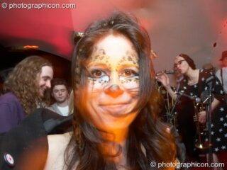A woman with painted face dances in the RumbleTeaser room at The Synergy Project. London, United Kingdom. © 2008 Photographicon
