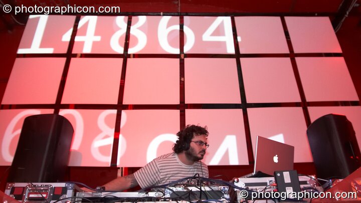 Justin Chaos (Point Red / Indica) DJs on the Future Music stage behind which is a projection screen by Inside Solutions at Luminopolis (formerly The Synergy Project). London, United Kingdom. © 2008 Photographicon