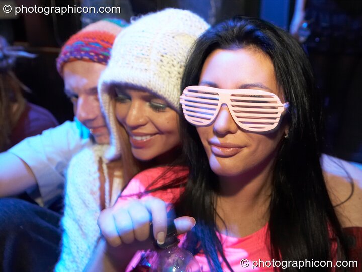 A woman wearing slitted glasses sits in the inSpiral Lounge at Luminopolis (formerly The Synergy Project). London, United Kingdom. © 2008 Photographicon
