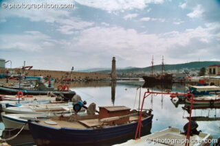 Boats and buildings reflected in the water of the harbour at Rethymno. Rethymno, Greece. © 2002 Photographicon